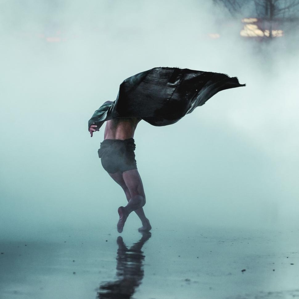 SQ dancer in motion amidst dramatic fog copy